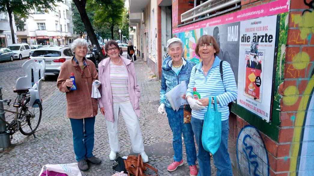 Vier Frauen auf einem Gehweg schauen in die Kamera